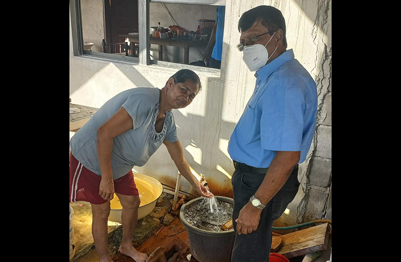 CEO of GWI, Shaik Baksh, engaging a resident of Lusignan on the benefits of the new well