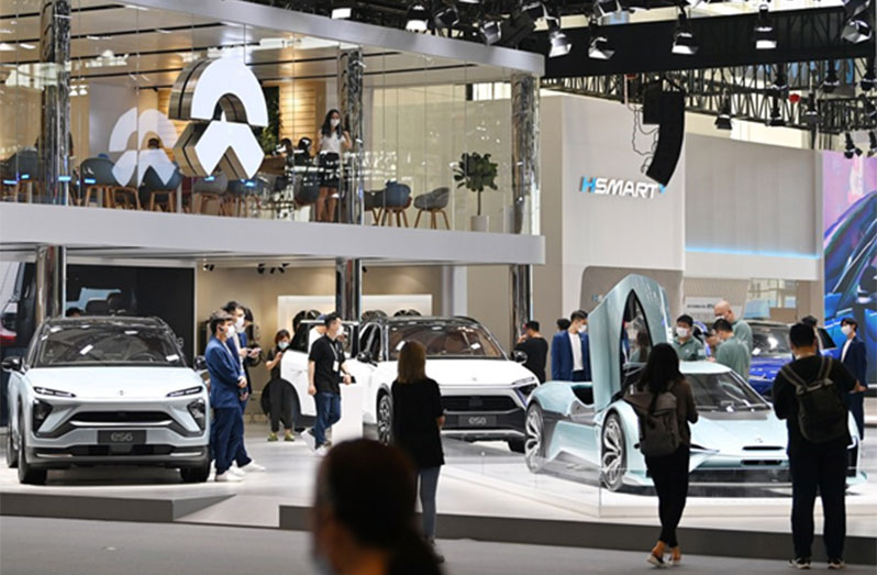 Visitors view electric cars during China (Tianjin) Auto Show 2021 in north China's Tianjin, Sept. 29, 2021. (Xinhua/Li Ran)