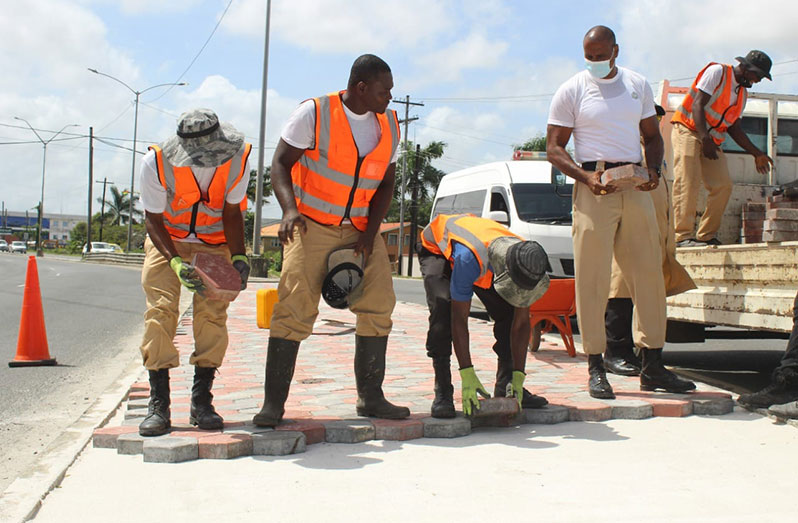 Ranks from the Force’s Construction Department, under the supervision of Sergeant Vickram Loaknauth of the Tactical Services Unit paving the median at Rahaman’s Turn, East Bank Demerara.  This project follows on the heels of the recent massive City-wide clean-up, spearheaded by President, Dr. Irfaan Ali (Guyana Police Force photograph)