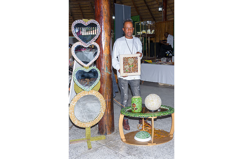 Frankie Limerick displays some of his craft products at his booth at the Duty-Free shop (Delano Williams photo)