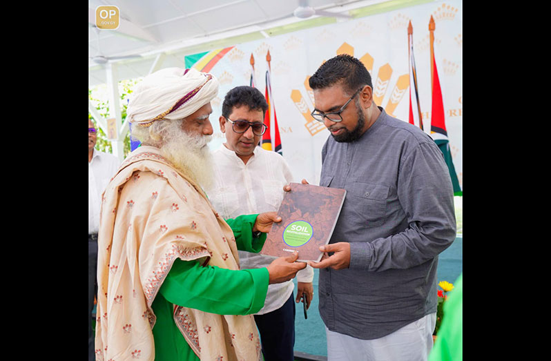 President Dr. Irfaan Ali (right) has joined the ‘Save Soil Movement’ by Sadhguru (left) who is on a one-day visit to Guyana. Attorney General, Anil Nandlall, SC, look on as the two engage in discussions on Saturday at State House (Office of the President photo)