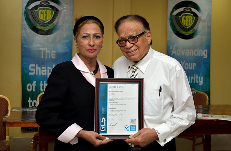 GEB Chief Executive Officer Maurice Amres, and his wife, Chief Finance Officer Chandra Amres with the company’s certification on Thursday (Elvin Croker photo)