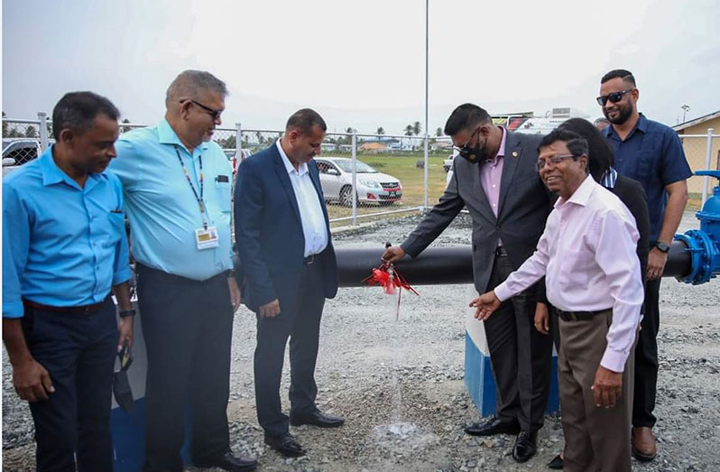 President Dr. Irfaan Ali commissions the new water system at Lusignan while Minister of Housing and Water, Collin Croal; CEO of GWI, Shaik Baksh and other officials look on (DPI photo)