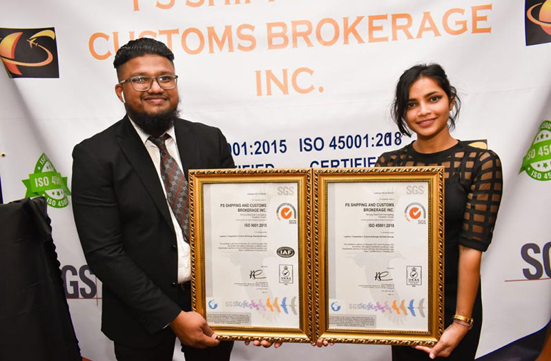 CEO of PS Shipping and Customs Brokerage (PSSCB) Inc., Phil Surooj and his wife, Alisha Singh, display the two ISO certificates which the company recently received