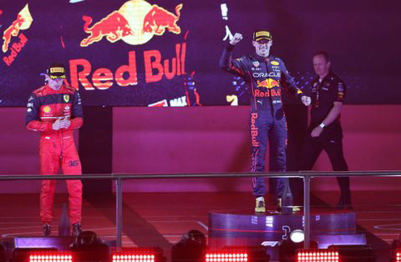 Formula One F1 - Saudi Arabia Grand Prix - Jeddah Corniche Circuit, Jeddah, Saudi Arabia - March 27, 2022 Red Bull's Max Verstappen celebrates winning the race on the podium with second placed Ferrari's Charles Leclerc REUTERS/Ahmed Yosri