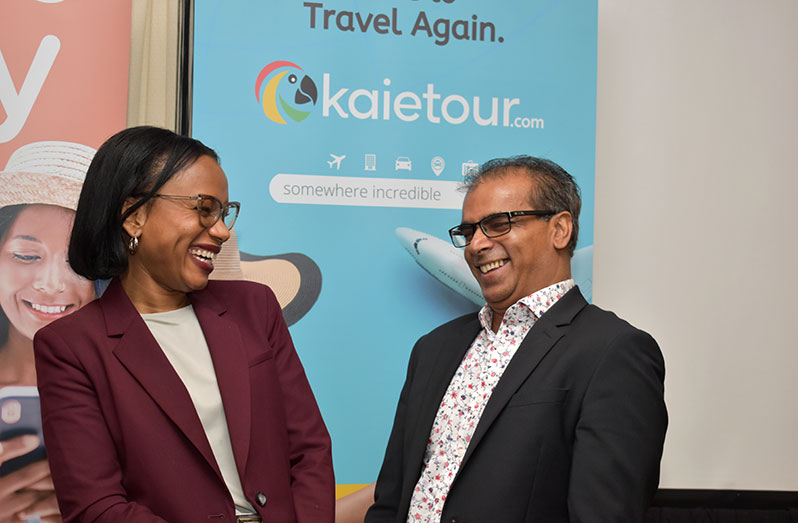 Minister of Tourism, Industry and Commerce, Oneidge Walrond and founder of the Kaietour app, Saludeen Nausrudeen sharing a light moment at the brief ceremony on Friday evening (Carl Croker photo)