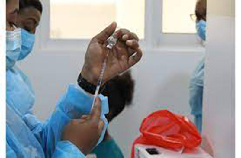 A nurse at the National Infectious Diseases Hospital at Liliendaal, Greater Georgetown, preparing to administer a dose of the Oxford-AstraZeneca vaccine to a local healthcare worker (Vishani Ragobeer photo)