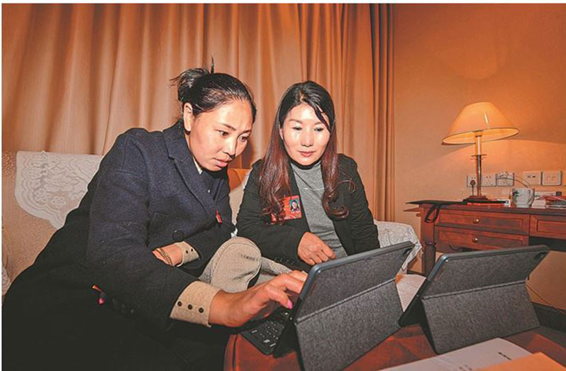 Tsering Tsodan (left) discusses her motions with Kelsang Dekyi, a fellow deputy of the National People’s Congress from Tibet autonomous region, in Beijing on March 3. (Photo by Tentsen Shinden/Tibet Daily)