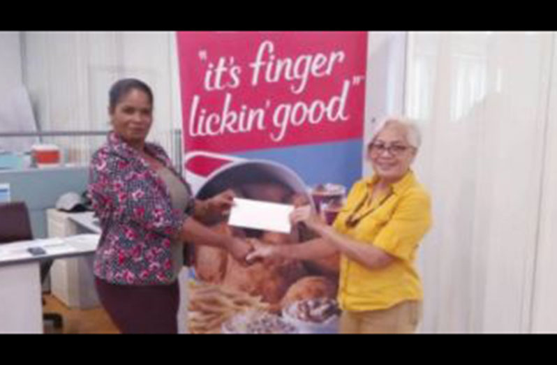 KFC rep Pamella Manasseh hands over the sponsorship cheque to GMR&SC secretary Cheryl Gonsalves (right)