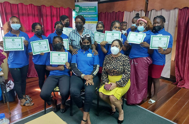 Some of the young mothers who recently graduated from a life skills training programme conducted by the Ministry of Education pictured with the National Health and Family Life Education Coordinator, Colleen Cameron (standing fifth from left) and Carnegie Principal, Sharmaine Marshall (sitting, right)