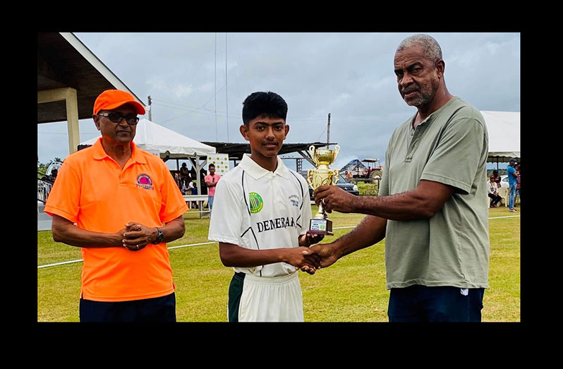Player-of-the-Match Darwin LaRose (centre) receives his trophy from former Guyana and West Indies off-spinner Clyde Butts in the presence of Essequibo Cricket Board president Deleep Singh