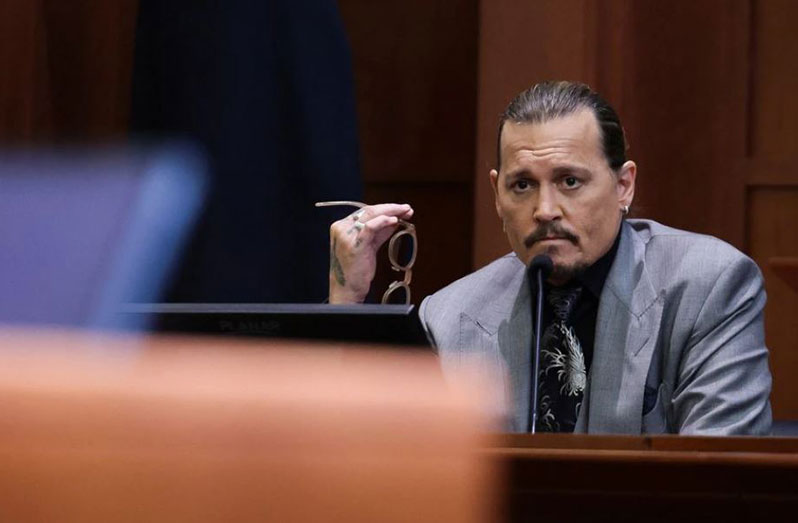 Actor Johnny Depp looks on at the end of the second day of his testimony during the defamation trial against his ex-wife, Amber Heard, at the Fairfax County Circuit Courthouse in Fairfax, Virginia, U.S., April 20, 2022. REUTERS/Evelyn Hockstein/Pool