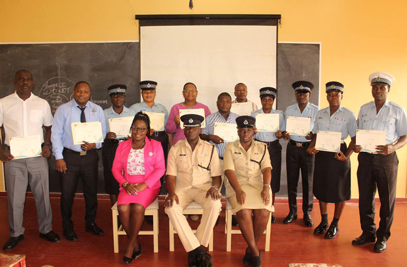 Force’s Training Officer (ag), Superintendent Keithon King (seated in middle) flanked by the certified police sergeants and other officials