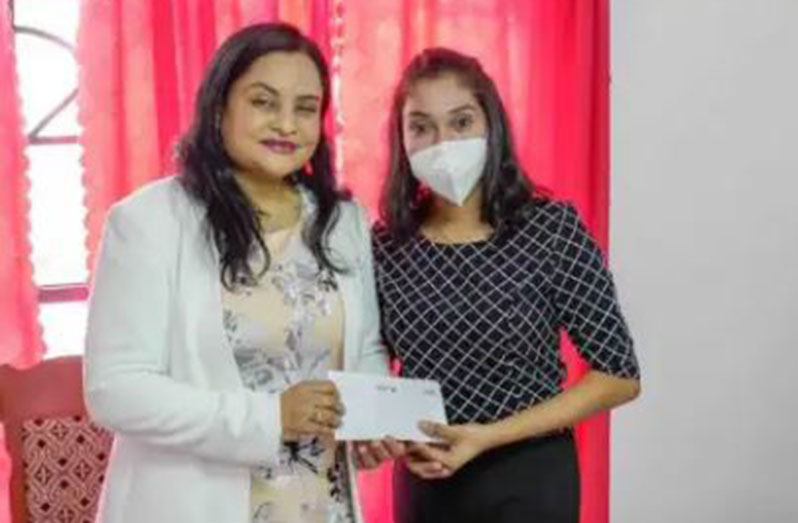 Human Services and Social Security Minister, Dr. Vindhya Persaud handing over a grant to a recipient (DPI photo)