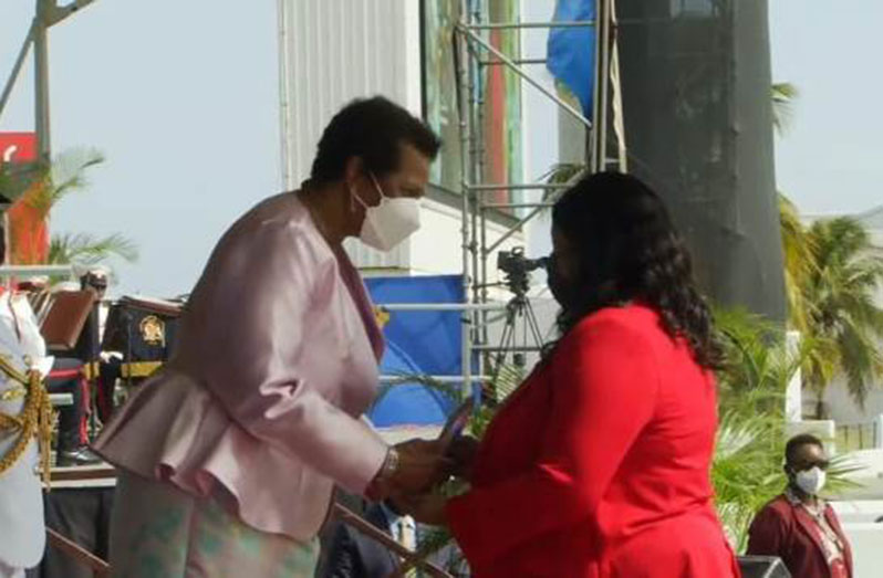 Geneva Tyndall, acting Consul-General of Guyana received the award from Dame Sandra Mason, President of Barbados (DPI image)