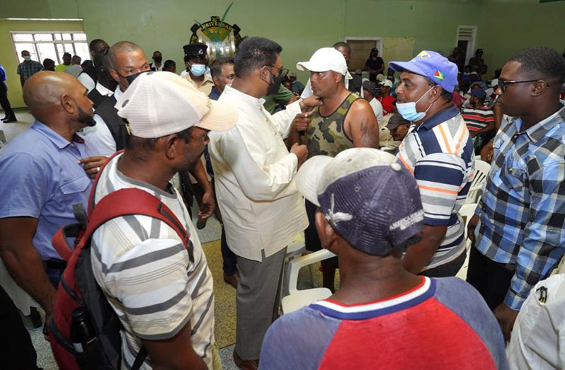 President Dr Irfaan Ali interacts with sugar workers of the Uitvlugt Estate (Office of the President photo)