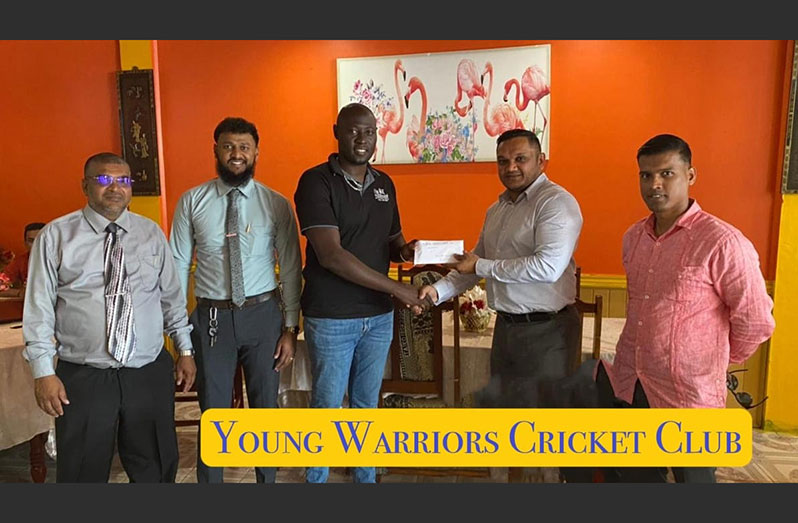 Hon. Minister of Natural Resources, Vickram Bharrat right, hands over the cheque to Aubrey David, vice-president of YWCC in the presence of REO Region 6, Narindra Persaud, Suresh Dhanai and a representative of the ministry.
