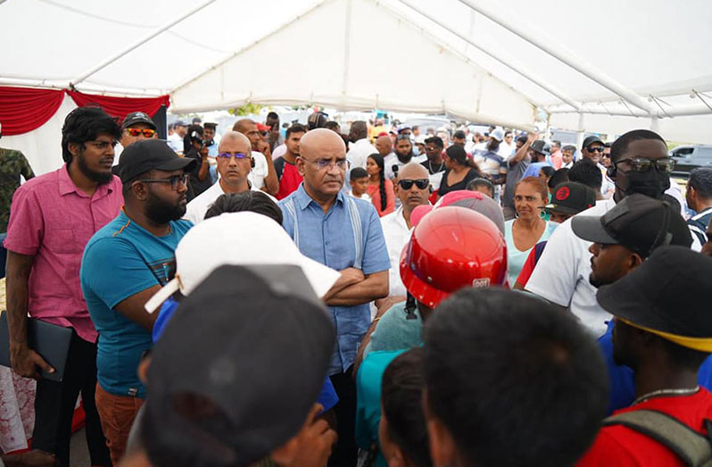 Vice-President, Dr Bharrat Jagdeo listens to concerns from residents during a community meeting at the Line Path Centre Ground on Monday (DPI photo)