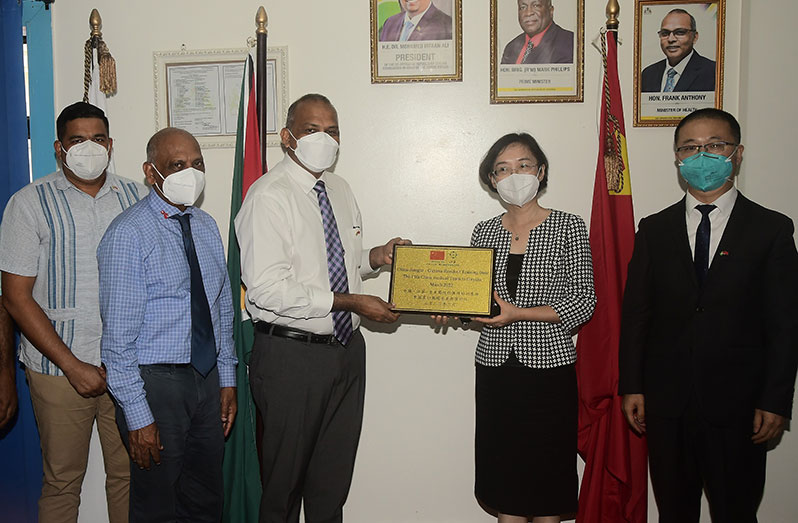 Minister of Health, Dr. Frank Anthony (third from left) receives a token from Chinese Ambassador to Guyana, Guo Haiyan (second from right) at the opening ceremony of the specialist training programme. They are surrounded by Head of the 17th Chinese Medical Brigade, Dr. Duan Yunfei (first from right); CEO of GPHC, Robbie Rambarran (first from left) and Adviser to the Minister of Health, Dr. Leslie Ramsammy (second from left) (Adrian Narine photo)