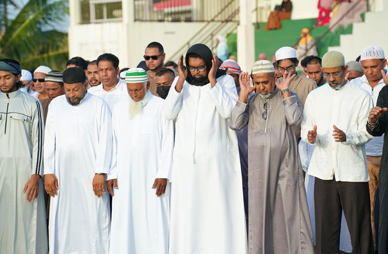 President Dr. Irfaan Ali (centre,front row) takes part in the Eid-ul-Fitr prayer on Monday morning at the Muslim Youth Organisation (MYO) ground on Woolford Avenue, Georgetown (Office of the President photo)