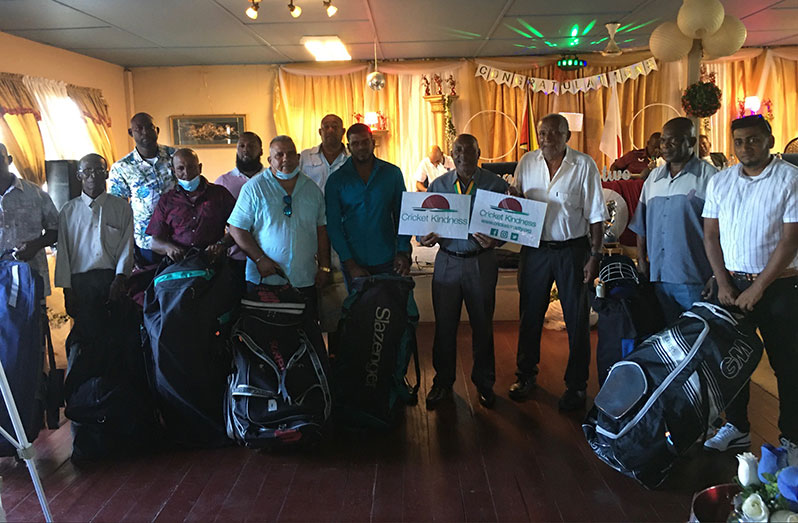 Representatives of the clubs pose with Sir Andy Roberts and Roland Butcher after receiving the gear.