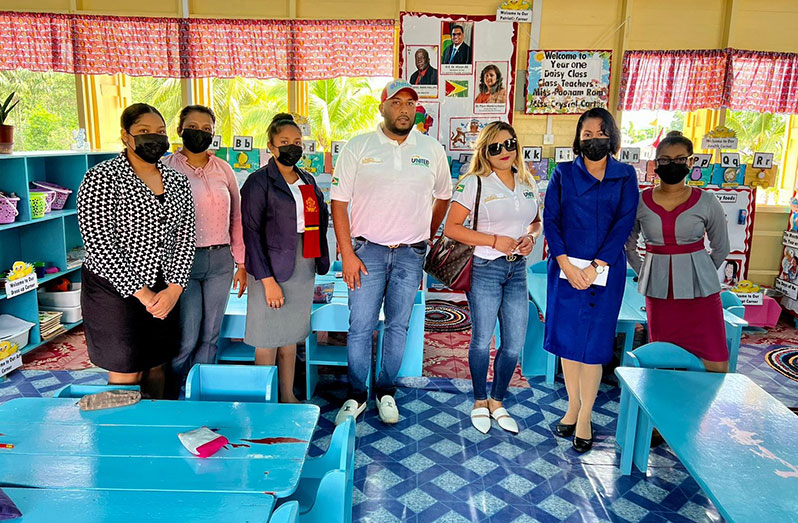 Owner of United Contracting, Safraz Ali, and his wife, Shaheeria Ali, handing over the monetary donation to the headmistress and teachers of the school