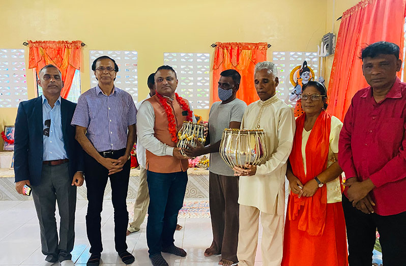 Indian High Commissioner to Guyana, Dr K J Srinivasa, handing over the tabla musical instruments to the members of Richmond Temple, Region Two.