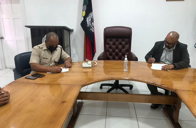 Acting Deputy Commissioner (Admin), Calvin Brutus and EPA's Executive Director, Kemraj Parsram, signing the Memorandum of Agreement