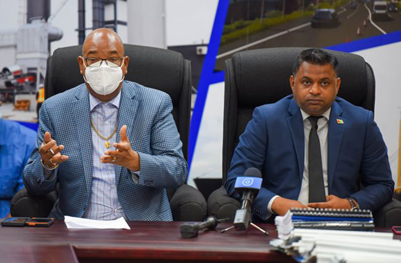 Minister of Public Works, Bishop Juan Edghill, and Minister within the Ministry of Public Works Deodat Indar at the contract signing ceremony