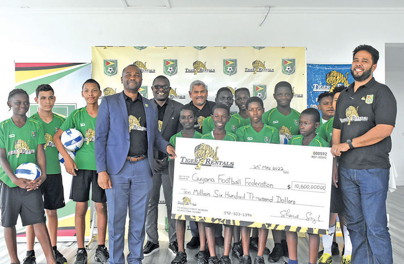 GFF president Wayne Forde receives Tiger Rentals Guyana Inc.’s cheque from Country Manager Shane Singh, following its announcement of a National U13 League