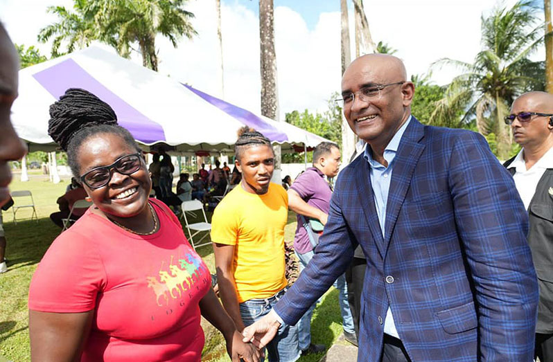 Vice-President Dr. Bharrat Jagdeo shares a light moment with a resident of Region 10 during his outreach there on Saturday (Office of the Vice-President photo)