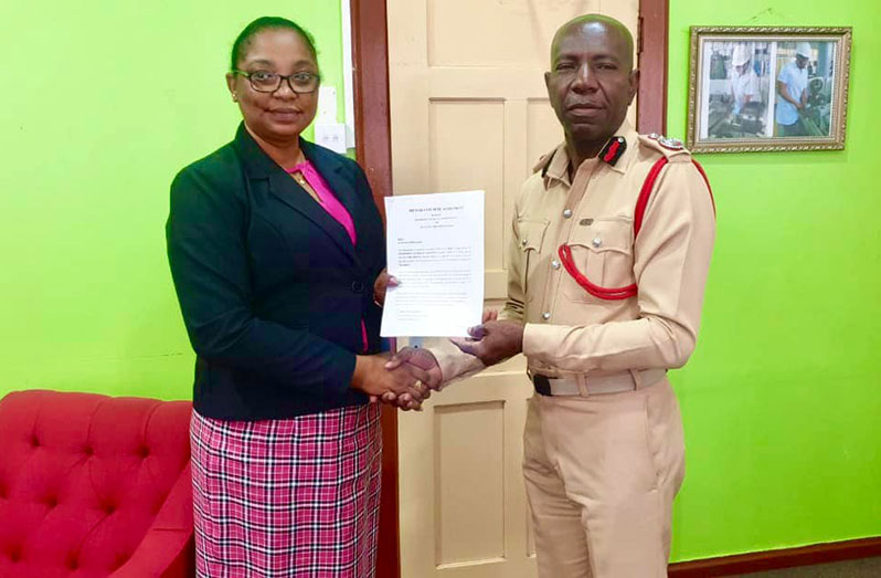 Chief Fire Officer (ag) Gregory Wickham and GTI Principal Renita Duncan-Crandon after signing the MoA