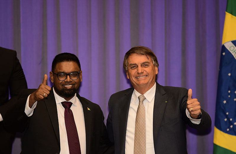 President of Guyana, Dr. Irfaan Ali and Brazil’s Head of State, Jair Bolsonaro share a light moment following engagements on Friday (Adrian Narine photo)