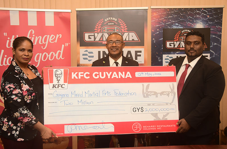 Pamela Manasseh, Marketing Manager at Beharry Restaurant Holdings presented KFC Guyana’s $2M cheque to members of the Guyana Mixed Martial Arts Federation (GYMMAF) (Adrian Narine photo)