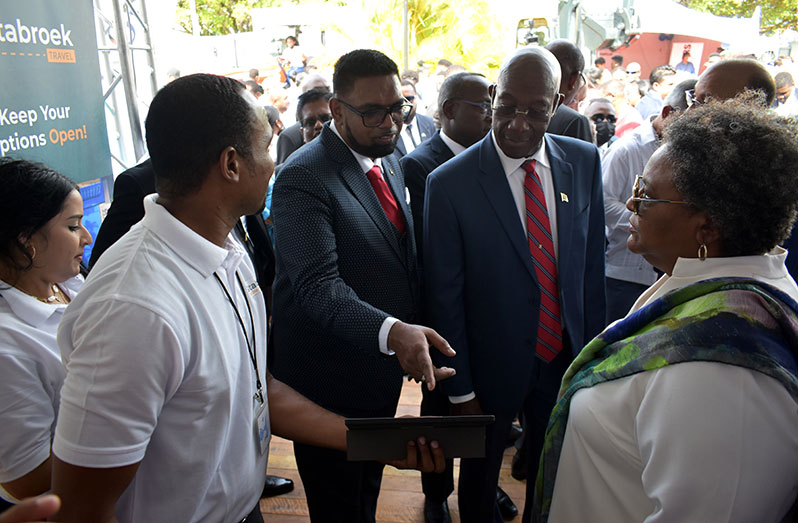 President Dr. Irfaan Ali (second left) invites Prime Minister of Barbados, Mia Mottley to make the first purchase on SOM, as Prime Minister of Trinidad and Tobago, Dr. Keith Rowley (third left) looks on