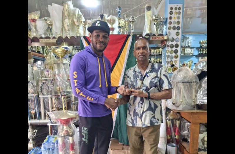 Carlston Harris (L) and Ramesh Sunich at the Trophy Stall in Bourda Market