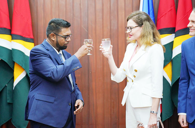 President, Dr Irfaan Ali shares a toast with Czech Republic’s Ambassador, Sandra Lang Linkensederova (Office of the President photo)