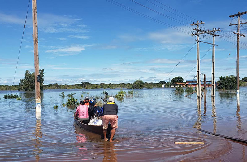 Residents navigate floodwaters in Region Nine (Photo by Norma Griffith, Information Officer RDC #9)