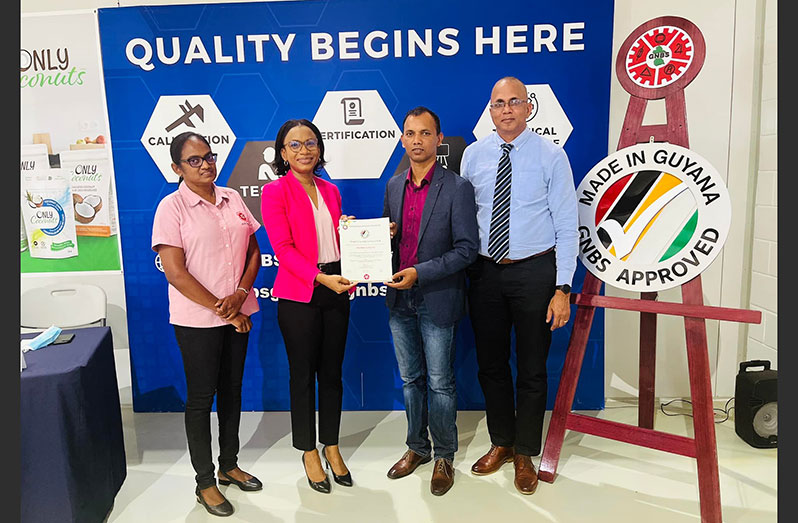 Tourism, Industry and Commerce Minister Oneidge Walrond hands over the Made in Guyana Certificate to General Manager of PGI, Lesley Ramlall. Also in photo are Executive Director (ag) of GNBS, Ramrattie Karan and GSMA Executive Director, Nizam Hassan