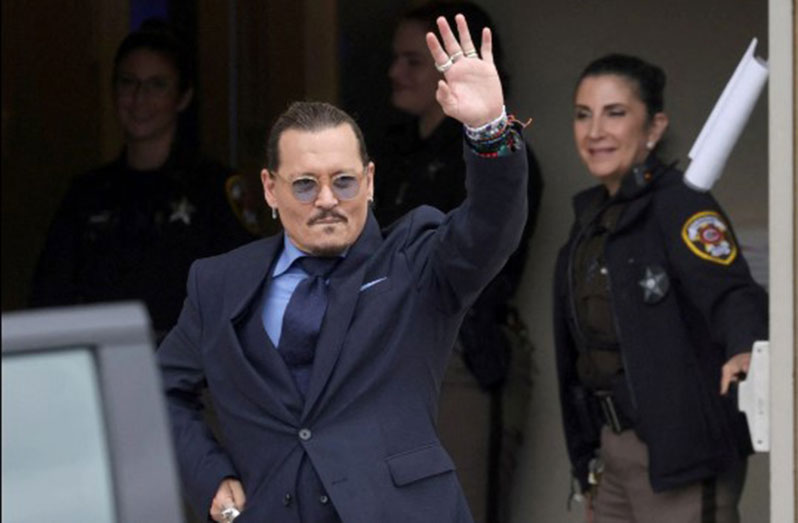 Actor Johnny Depp gestures as he leaves the Fairfax County Circuit Courthouse following his defamation trial against his ex-wife Amber Heard, in Fairfax, Virginia, U.S., May 27, 2022. REUTERS/Evelyn Hockstein