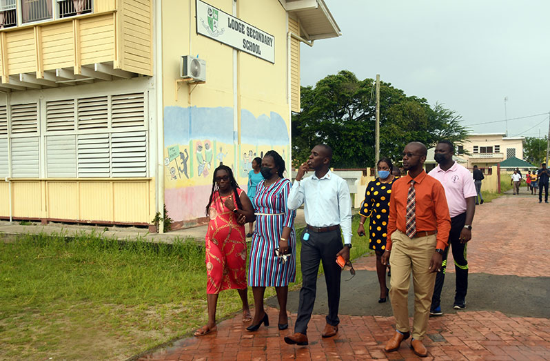 Teachers and union officials as they made their way into the school’s compound after the demonstration on Wednesday (Adrian Narine photo)