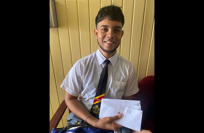 Anup Singh holds up the envelopes he collected from Region Two Department of Education