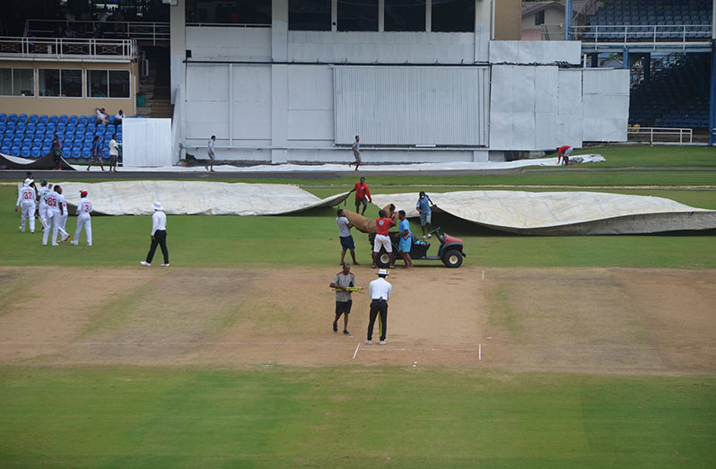 Rain had the grounds men very busy on day three at the Queen’s Park Oval