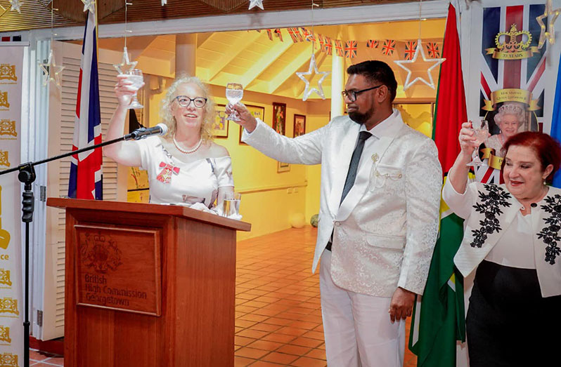 President Dr. Irfaan Ali; Minister of Parliamentary Affairs and Governance Gail Teixeira; and British High Commissioner to Guyana Jane Miller make a toast to commemorate the birth anniversary of Her Majesty, Queen Elizabeth II, and the relationship between Guyana and the UK (Office of the President photo)
