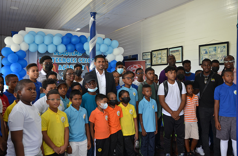Some campers and executives of the Malteenoes Sports Club flank Sport Minister Charles Ramson Jr