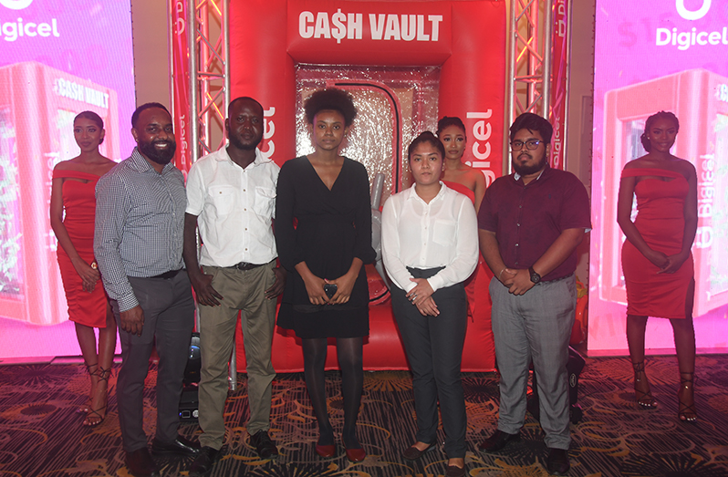 Digicel’s Marketing Manager Ramesh Roopchand (first from left) and media workers who won cash prizes during the launch of Digicel’s ‘Cash Vault’ promotion on Thursday (Adrian Narine photo)