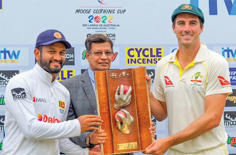 Dimuth Karunaratne and Pat Cummins pose with the Warne-Muralitharan Trophy, which they shared (AFP/Getty Image)
