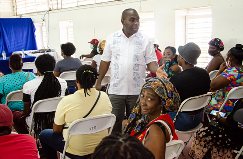 Minister within the Office of the Prime Minister with responsibility for Public Affairs, Kwame McCoy, speaking with residents of Sophia