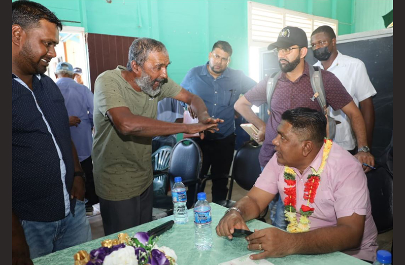 Minister Zulfikar Mustapha engages a farmer of Leguan
