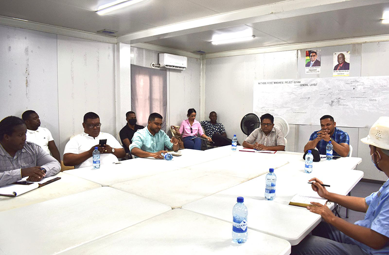 Senior Finance Minister, Dr. Ashni Singh (third from right), flanked by Natural Resources Minister, Vickram Bharrat and Local Government Minister Nigel Dharamlall and other officials, in discussion with Guyana Manganese Inc. representatives (Finance Ministry photo)